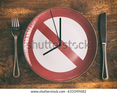 Skip breakfast concept with no symbol and clock on plate