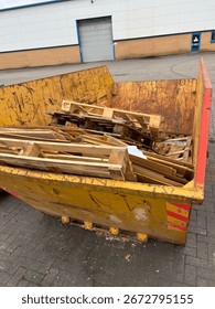 Skip with pallets in it