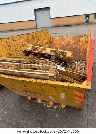 Skip with pallets in it