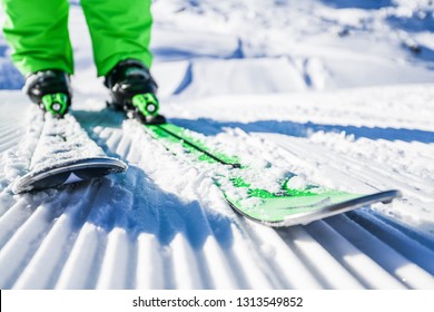 Skis And Boots Detailed From Front View. New Groomed Piste Or Slope. Lines In Snow With Ski.