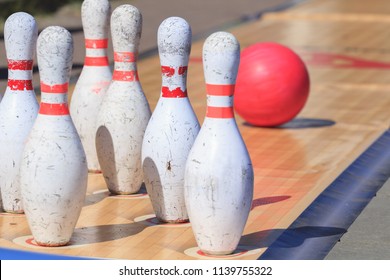 Skittles And Bowling Ball On The Outdoor Playing Field