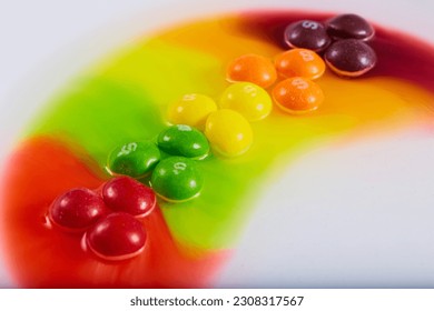 Skittles candy sugar water experiment rainbow color bleed vibrant rainbow arch background asset