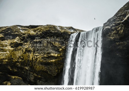 Skogafoss waterfalls in Iceland on a snowy day
