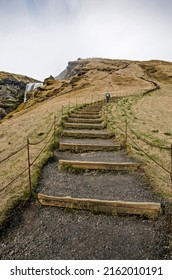 Skogar, Iceland, April 24, 2022: large staircase lading up the hill to the top of the Famous Skogafoss waterfall