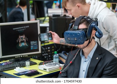 Skolkovo, Russia - October 21, 2019: VR Conference Visitor Tests Virtual Reality Helmet