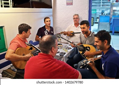 SKOPELOS ISLAND, NORTHERN SPORADES, GREECE- June 21, 2018. Famous Rebetiko musician and singer, Giorgos Xintaris, with his sons, Antonis & Thodoris (+ friends), playing at "Anatoli" tavern.