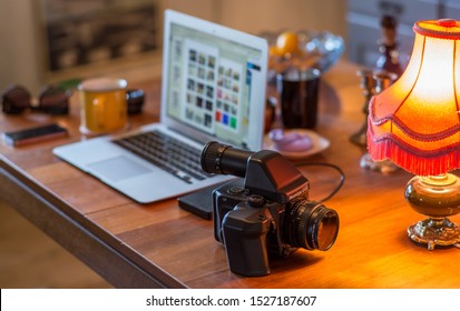 Skovde / Sweden - October 12 2018: A view of a medium format analog camera on a table in front of a laptop and other various objects. - Shutterstock ID 1527187607