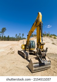 Skrunda, Latvia - May 3, 2022: Yellow excavator JCB JS 220 LC is located in a quarry.
