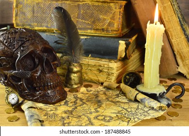 Skull and burning candle  pirate map   old books