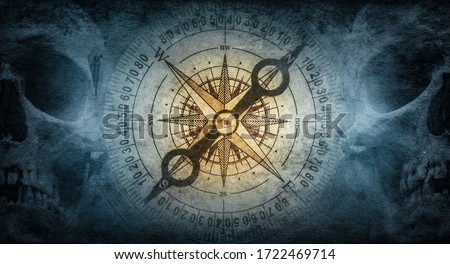 Skull of an old sailor pirate and vintage compass on a background of old paper. Symbol of travel, adventure, geographical discoveries, history, treasure hunt. Pirate and nautical grunge background.