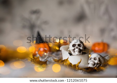 Skull on an old used thick candle. Scary Halloween background. Closeup