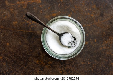 Skull as a spoon with a pot of white sugar.