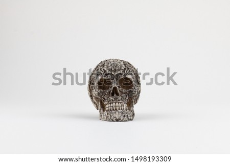 Skull trinket. Textured skull isolated on white. Stone skull. Souvenier from day of the death.