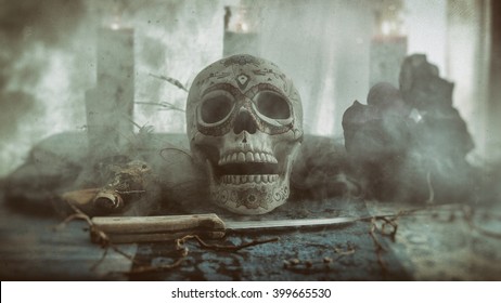 Skull Voodoo Smoke Ritual. Voodoo related objects on a table including a skull, a knife and candles. Smoke or mist.