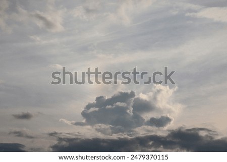 sky background with clouds. blue sky background with tiny clouds. rainy day. The sky has a faint rainbow.