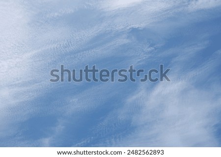 Sky Background - Delicate, Wispy and Silky Smooth Cirrus or Cirrostratus Clouds Look Like Thin Veils of Smoke Floating in the Daylight Sky