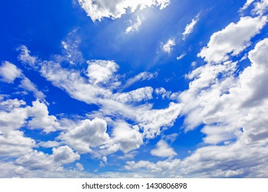 Sky background with the fluffy white clouds 
