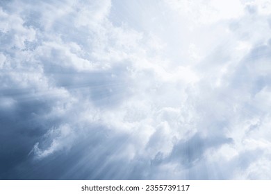 Sky background. The rays of the sun break through dense dramatic clouds