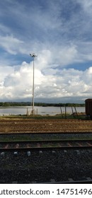 The sky between the clouds, the water below and the soil beside it.