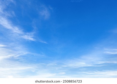 The sky is blue and clear with no clouds. The sun is shining brightly, making the sky look even brighter. Scene is peaceful and serene