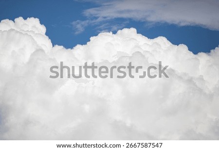 The sky is blue and cloudy. The clouds are white and fluffy