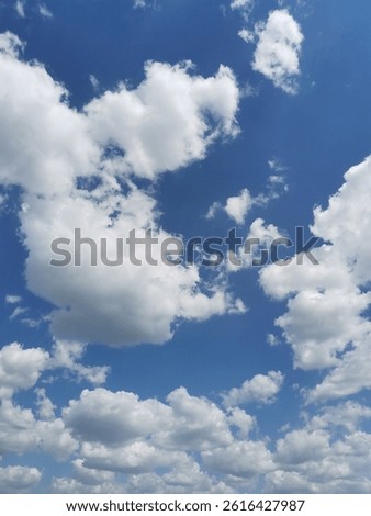Sky blue with fluffly white clouds background texture day time spring season panorama relax landscape 