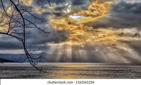 sky breakthrough over the sea with dark cloud and orange sun light, very amazing sky in the winter - Powered by Shutterstock