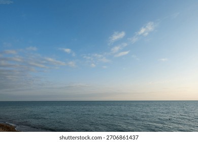 The sky is clear and blue with no clouds. The ocean is calm and peaceful. The scene is serene and relaxing