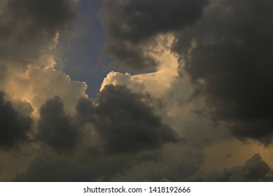 Sky And Cloud Background. Silver Lining Concept. Storm Cloud Surrounded A Light Touched Tip Of A Cloud Floating Higher Above.