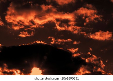 Sky With Clouds In Autumn At Sunset Of The Day. The Sun Sat Down In A Thundercloud.  Light Flares On The Camera Lens From The Sun. Shooting Against A Light Source. Selective Focus.