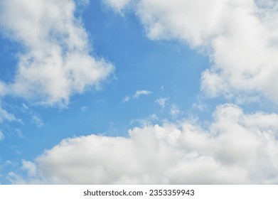 Sky and clouds, low angle view. Cloud with blue sky. White clouds in the blue clean bright sky close-up. Light-headed, dizzy. Dramatic white clouds and sunlight.Nice blue sky with sun beam with cloudy - Shutterstock ID 2353359943