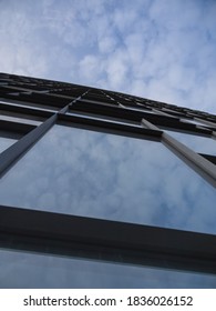 Sky and clouds reflection in the glass wall of a building