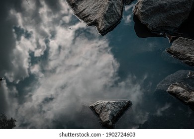 Sky And Clouds Reflection On Water Surface.