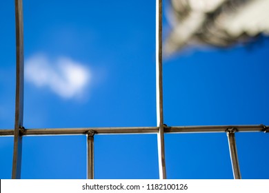 Sky And Clouds Seen Through Metal Gate.  Concept For Shattering The Glass Ceiling Or Freedom.