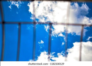 Sky And Clouds Seen Through Metal Gate.  Concept For Shattering The Glass Ceiling Or Freedom.