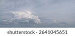 sky is cloudy and the clouds are white. sky is mostly blue with a few clouds scattered throughout