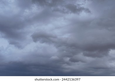 The sky is cloudy, with low, heavy clouds covering the sky with a gray veil. Cumulonimbus have formed, indicating the formation of a thunderstorm. Wallpaper. 