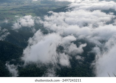 The sky is cloudy and the mountains are in the background. The clouds are white and fluffy, creating a peaceful and serene atmosphere