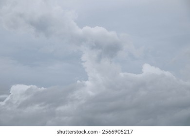 The sky is cloudy with thick gray cloud formations, looking like a unique abstract shape.