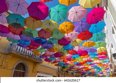 The sky of colorful umbrellas. Street with umbrellas.Umbrella Sky Project in Agueda, Aveiro district, Portugal. Agueda.Background colorful umbrella street decoration.