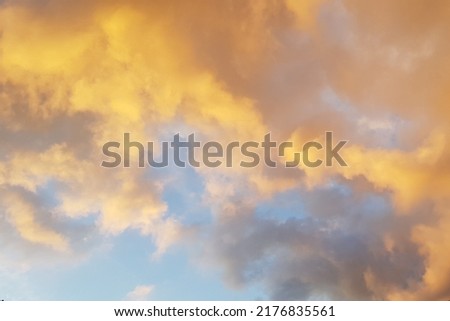 Sky with colorful yellow-purple clouds  at sunset after a thunderstorm. Abstract sky background. 