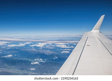 Sky With Cumulus And Cirrus Clouds, Airplane Wing And Mountains Below, Aerial View Above Slovenia.