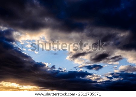 The sky is dark and cloudy, with a few rays of sunlight peeking through the clouds. Scene is somewhat ominous and foreboding, as if a storm is brewing