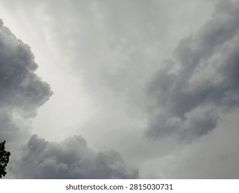 The sky is dark with gathering thick clouds, signaling approaching rain; the atmosphere is overcast and the surroundings appear gloomy. Carbon dioxide emissions, the greenhouse effect, and global warming are the causes of climate change.