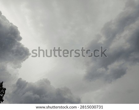 The sky is dark with gathering thick clouds, signaling approaching rain; the atmosphere is overcast and the surroundings appear gloomy. Carbon dioxide emissions, the greenhouse effect, and global warming are the causes of climate change.