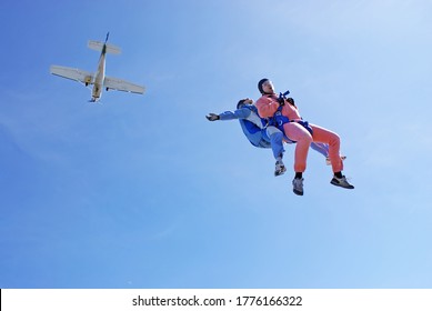 Sky Dive Tandem Jump With Blue Background