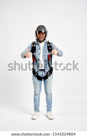 Sky diving men. Gesture class. Men in parachute equipment and helmet shows gesture class. Skydiving men in parashute.
                               