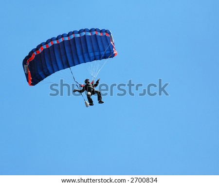 Sky Diving with space in solid blue sky for your text.