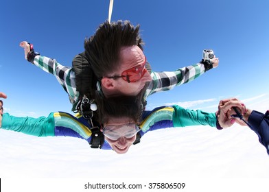 Sky Diving Tandem Holding Hands