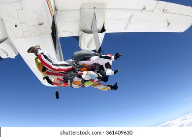 Sky Diving Tandem Jumping From The Plane In The Blue Skies